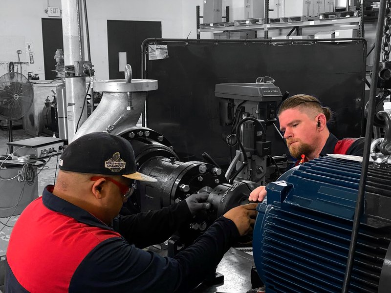 Pinnacle-Flo technicians assembling a pump and driver